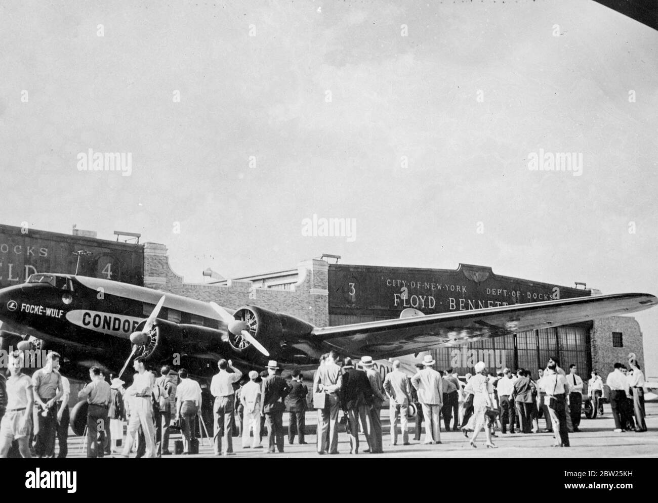 German transatlantic plane brings back pictures of own arrival in New York. These pictures, showing the arrival of the German Focke-Wulf Fw 200 Condorr 'Brandenburg' at Floyd Bennett Field, New York, after her secret first direct non-stop flight from Berlin across the Atlantic, were brought back to Europe by the machine on her return flight. The plane, piloted by captain Alfred Hencke, breached New York in just under 25 hours, and flew back in a few minutes under 20 hours, a record. Photo shows, the 'Brandenburg' on arrival at Floyd Bennett field, New York.. 15 August 1938 Stock Photo