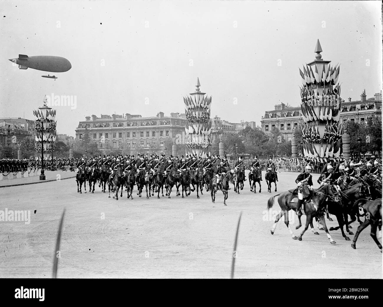 King and Queen receive tumultuous welcome in Paris. Welcomed by 1 million cheering people and the thunder of 101 gun salute, the King and Queen arrived at the Gare Bois de Boulogne on their State visit to Paris. Accompanied by President Lebrun of France and Mme Lebrun , they made the 4 mile drive through decorated streets lined with troops and crowds to the Qui d' Orsay Palace , where they are staying. Photo shows, the Repubican Guard in the procession through Paris. 19 July 1938 Stock Photo