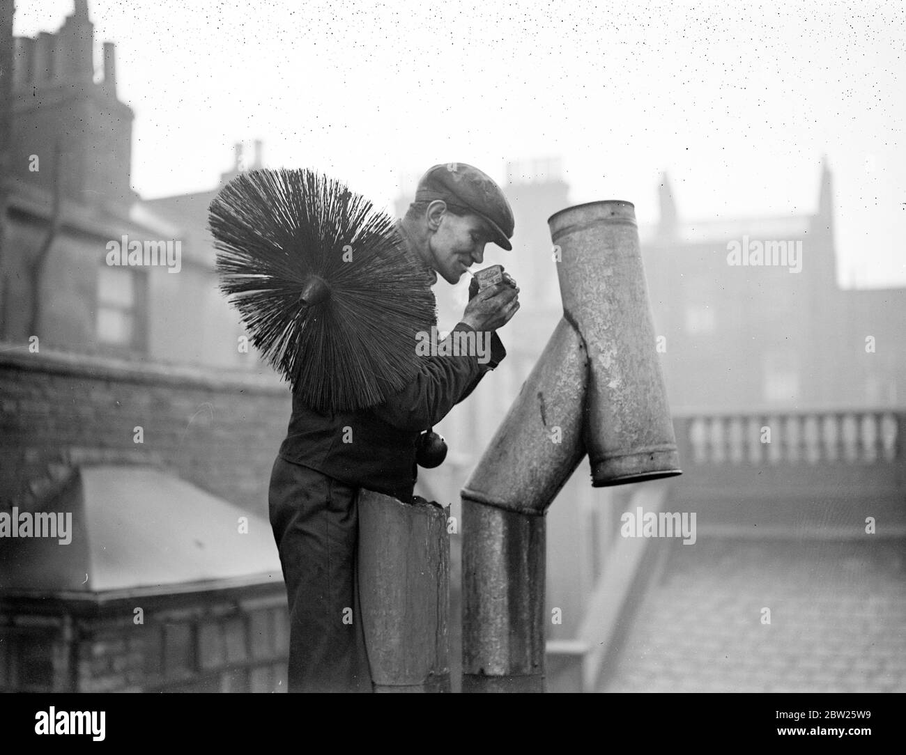 A Day in the life of a chimney sweep. Chimney sweep has a quick break. Stock Photo