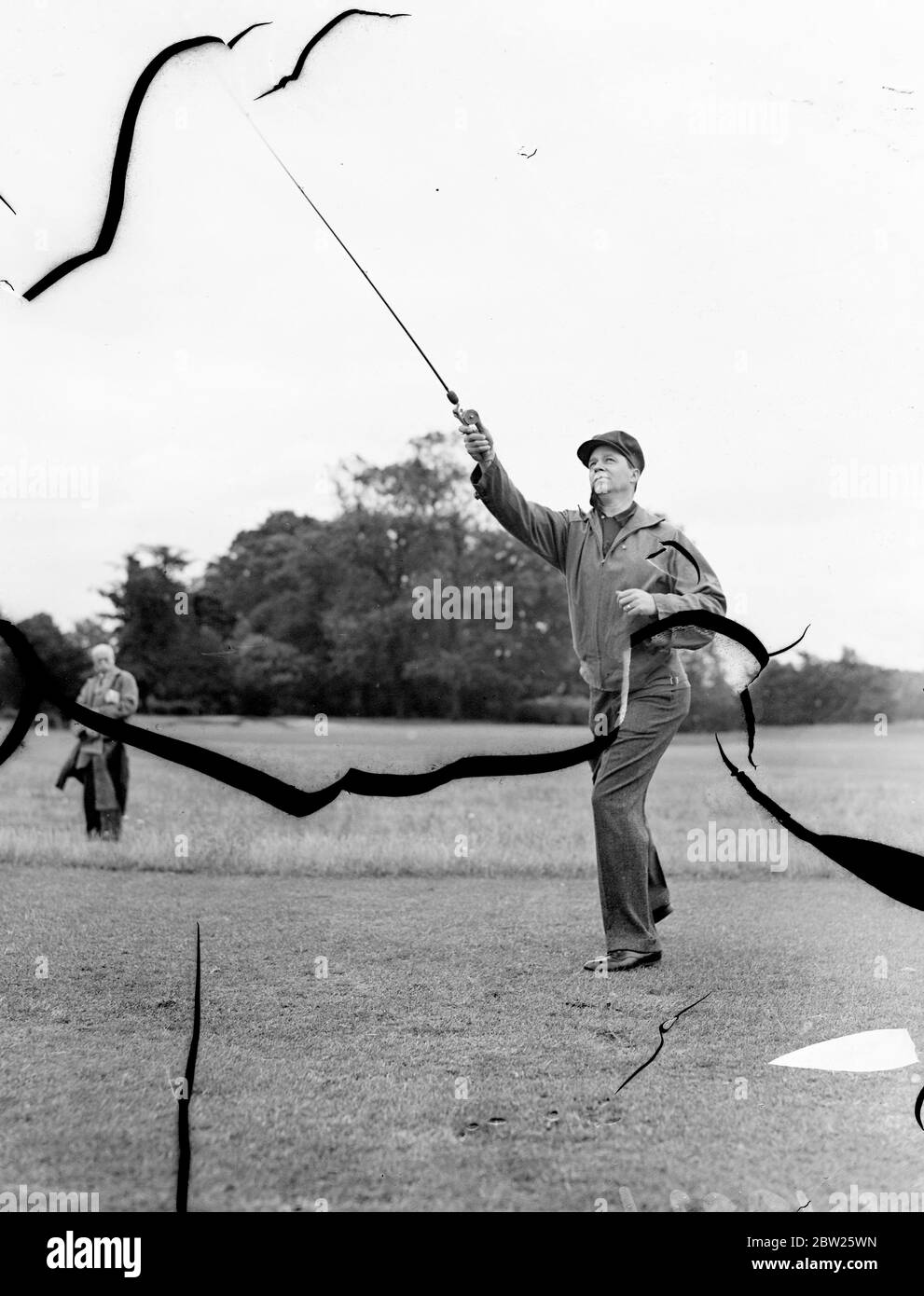 American Champion competes in London fly casting.. Champion fly and bait casters from Britain, the Continent and America competed in the annual international tournament of the British Casting Association at the Ranelagh Club, barnes, London. Photo shows, Marvin Hedge, the American international champion, competing in the half ounce Bait Distance event.. Stock Photo