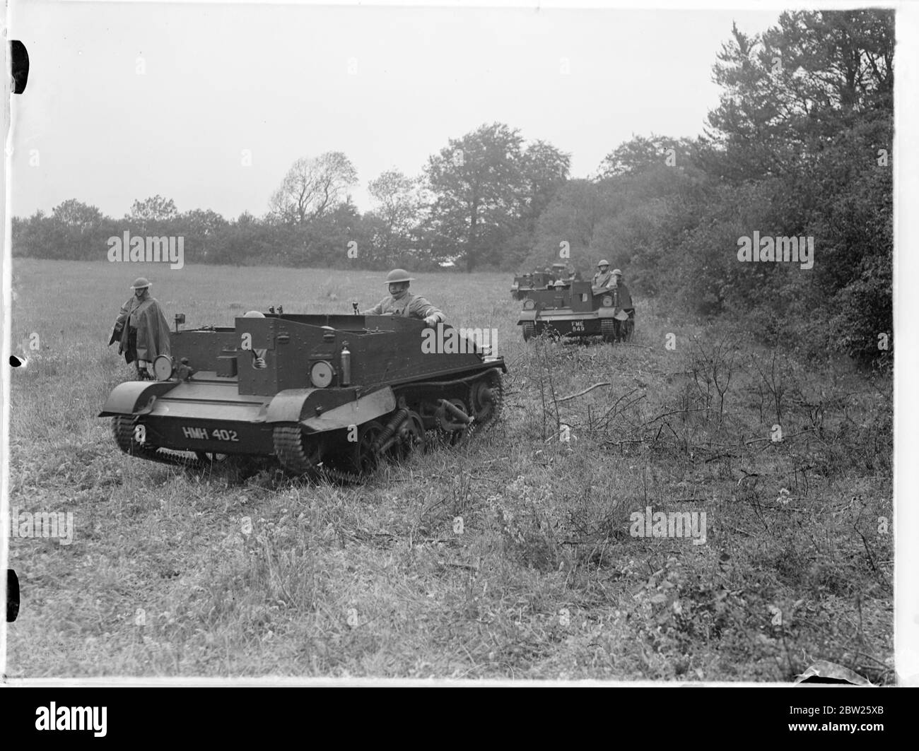 Recently, mechanised Brigade in Hampshire manoeuvres. Divisions of the recently mechanised 1st Cavalry Brigade are cooperating with the Tank Brigade in the important army manoeuvres in the Hampshire area. Photo shows, Bren carriers manned by men of the 1st Battalion Gordon Highlanders moving into action cross a field near Winchester. 16 August 1938 Stock Photo