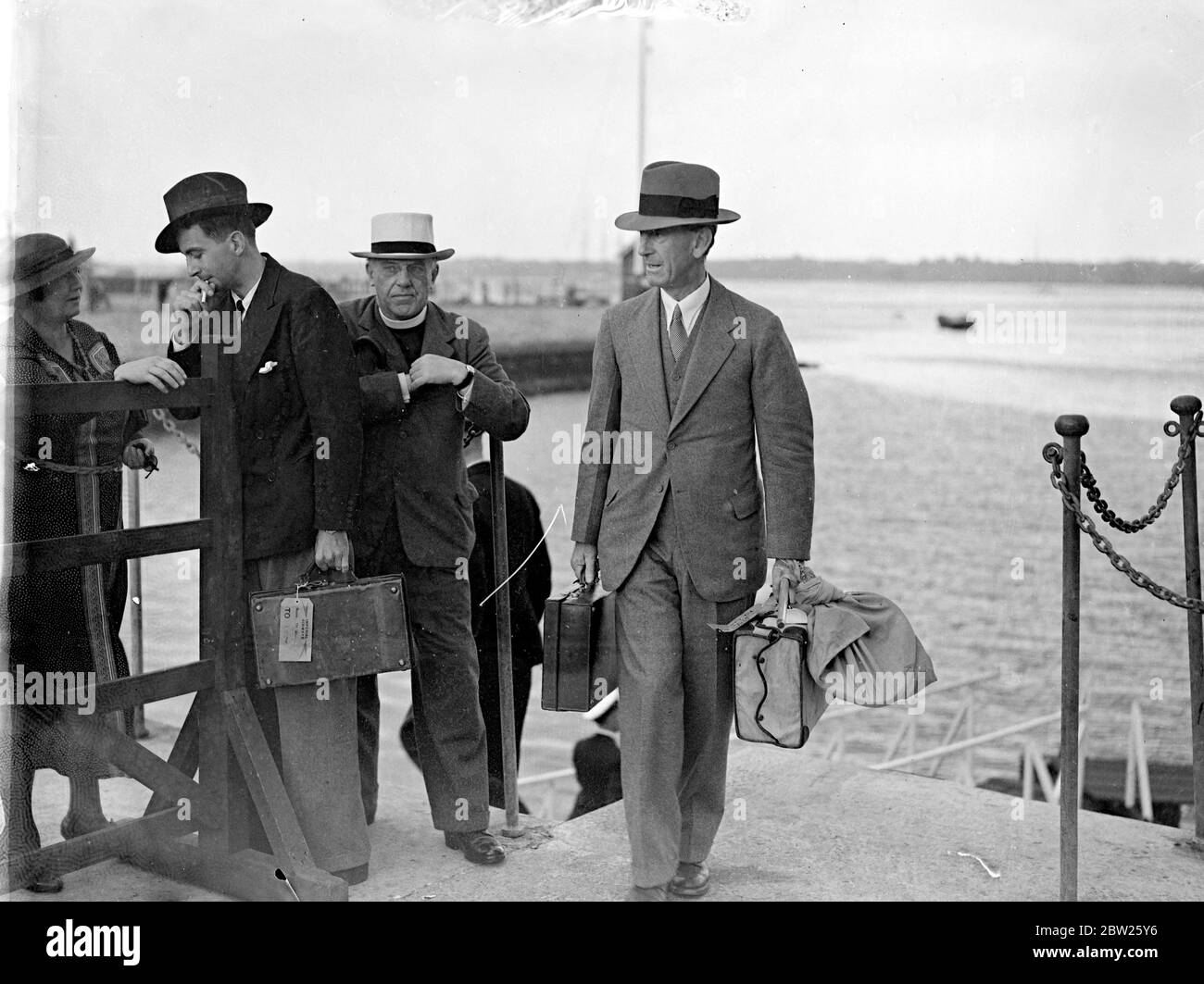 Governor of Sind flies home on leave. Sir Lancelot Graham, Gov of Sind (India) , arrived at Southampton on the Imperial Airways Plane 'Coorong' on leave. Photo shows, Sir Lancelot Graham , carrying his bags ashore at Southampton. 4 August 1938 Stock Photo