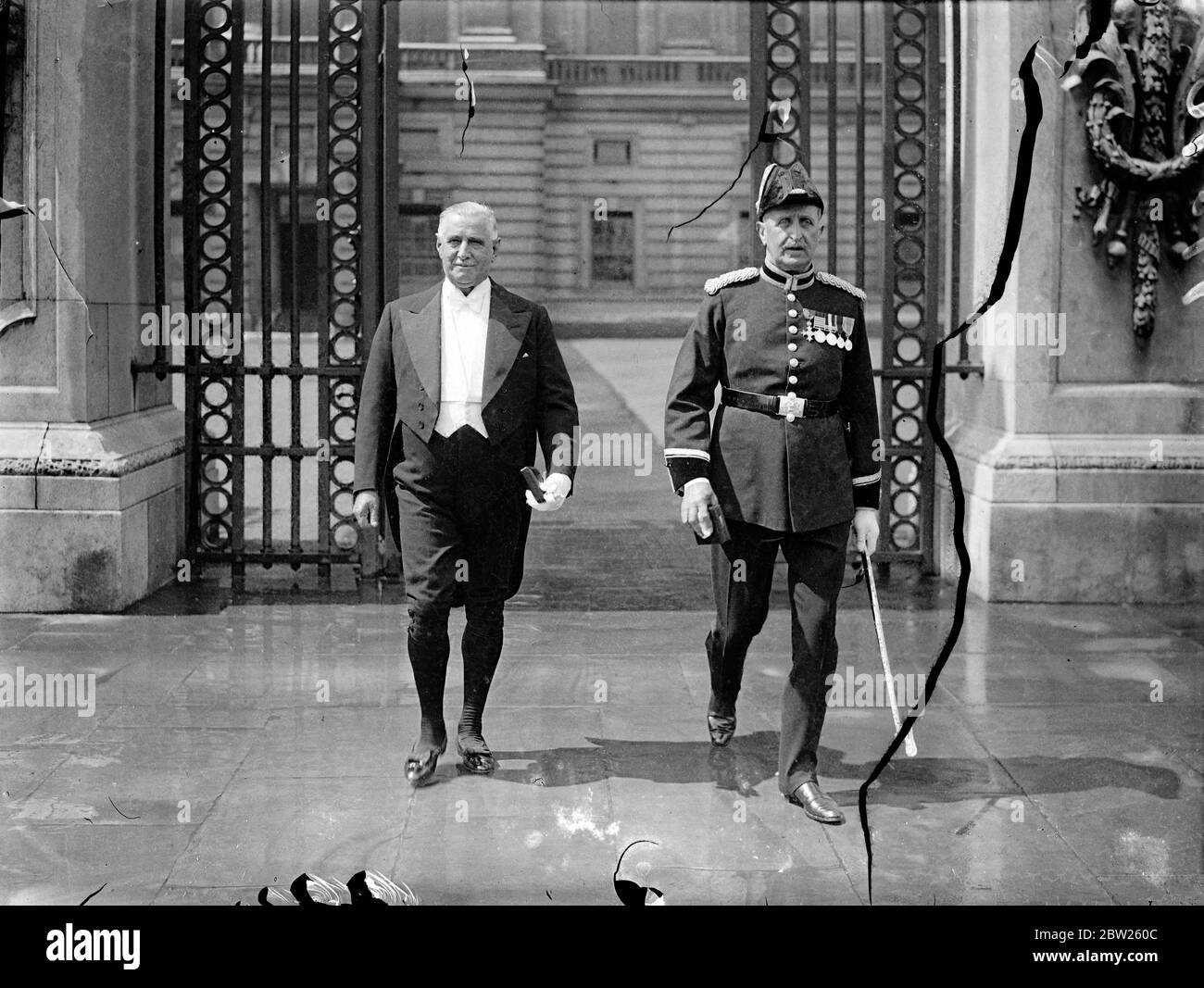 King holds Investiture at Buckingham Palace. An Investiture was held by the King at Buckingham Palace, the first to take place there for several years. The attendance cosisted largely of admissions to and promotions in the higher classes of the Orders of Chivalry, made in the Birthday Honours. Photo shows, Mr William Dunn of Barnstaple and Major Cockburn, Chief Constable of Hampshire, arriving at Buckingham Palace. 5 July 1938 Stock Photo