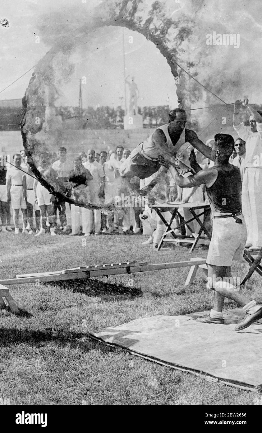 Mussolini puts his leaders through the hoop. Signor Achille Starace, Secretary General of the Fascist Party, vaulting wicked looking bayonets in one of the physical fitness tests for fascist officials instituted by Mussolini and carried out at the Mussolini Forum in Rome under the eye of the Duce. The National leaders were obliged to vault a horse, clear a row of bayonets and jump a tank. Signor Starace and seven others were the only competitotrs to successfully complete the test. 2 July 1938 Stock Photo