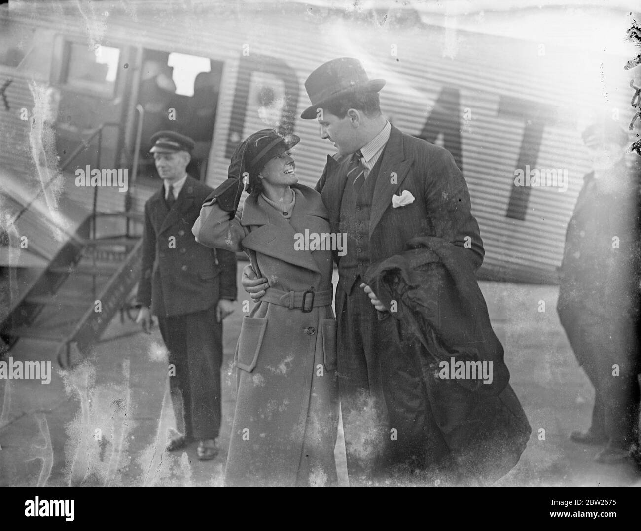 Ben Foord arrives home by air from Hamburg, welcomed by his wife. Ben Foord, the former British Empire heavyweight champion, who stood 12 rounds against Max Schmeling in Hamburg, arrived at Croydon by air from Hamburg art are suddenly changing his plans. He was greeted by his wife, at the aerodrome.. 1 February 1938 Stock Photo