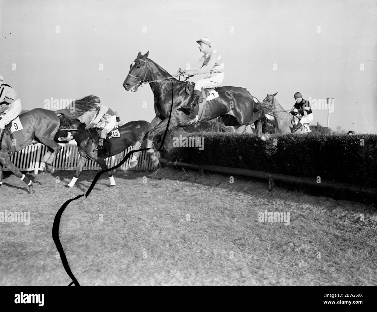 Grand National candidate runs at Kempton. Davy Jones, Lord Mildmay of Flete's horse which had a grand chance of winning the Grand National last year, but broke the rein and ran out at the last fence, is again entered for the Grand National on 25 March. Photo shows, Davy Jones, ridden by Mr A Mildmay, taking a jump in the Emblem Handicap Steeplechase at Kempton Park, near London. 2 March 1938 Stock Photo
