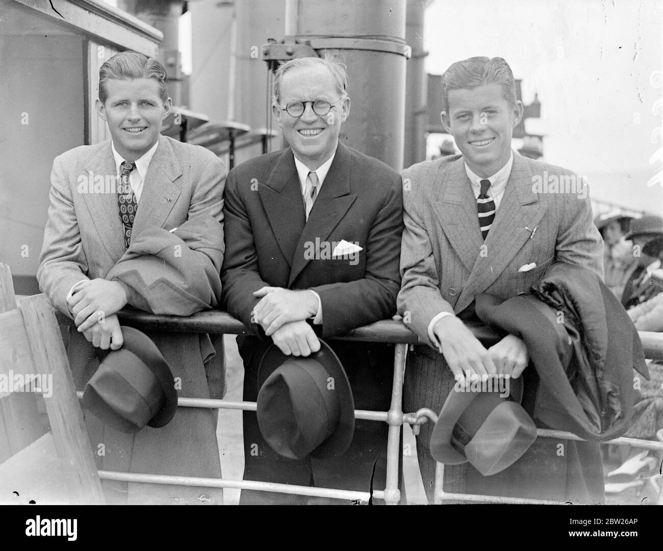 US Ambassador arrives back in England with two grown sons. Mr Joseph P Kennedy, the American Ambassador to London, arrived at Southampton on the 'Normandie' after his visit to the United States. He was accompanied by his two grown sons, Joseph, Jr who recently graduated at Harvard and John. Photo shows, Mr Joseph Kennedy with his two sons, Joseph Kennedy Jr (left) and John kennedy (right) on arrival at Southampton. 4 July 1938 Stock Photo