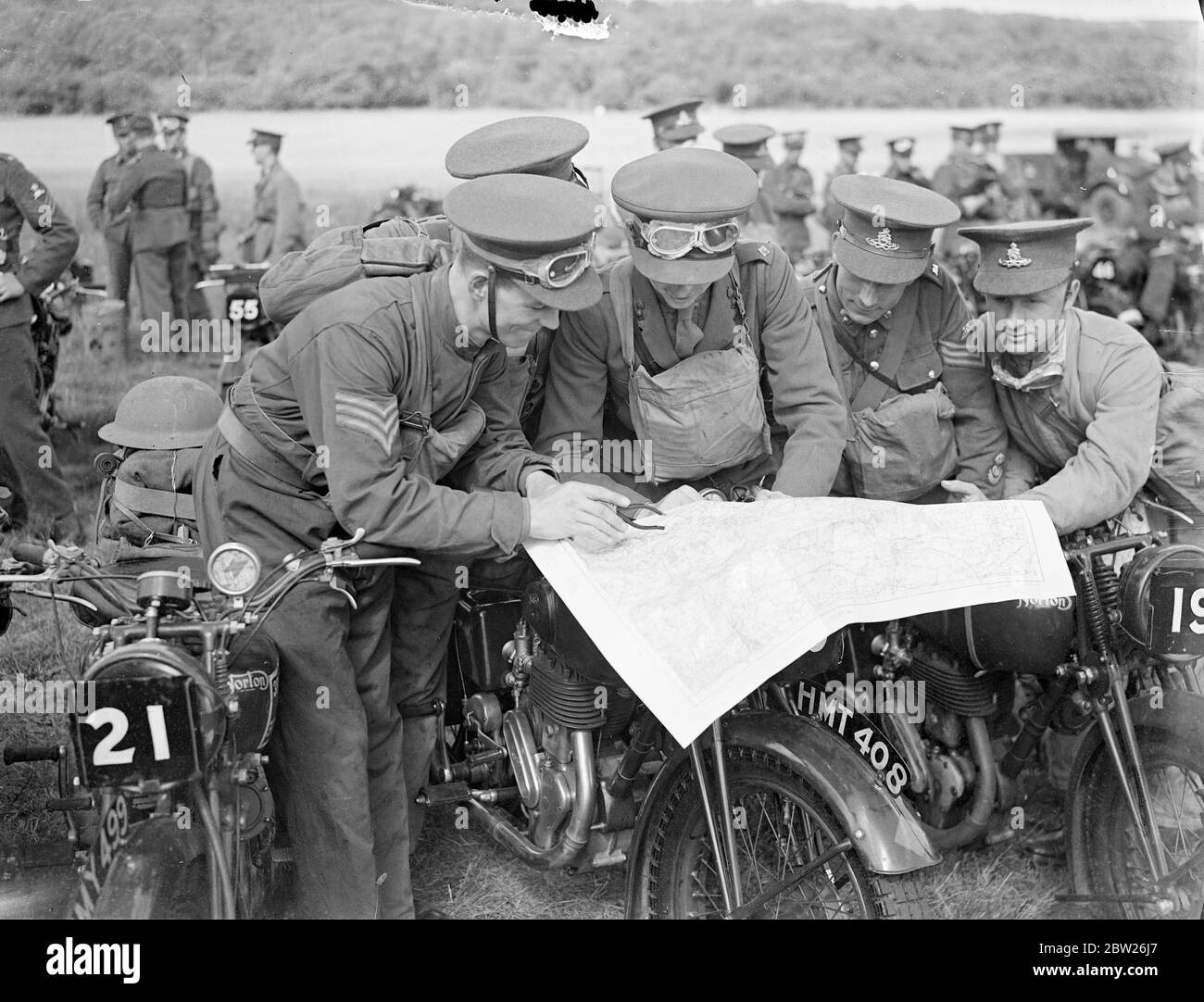 First army motor cycle reliability trials starts at Wimbledon. Army motor cyclists of the Eastern Command took part in the first of the Army Reliability Trials recently sanctioned by the War Office, which started from Wimbledon Common, London, and continued over a 50 miles course. Photo shows, Competitors working out their course on a map before the start. 30 June 1938 Stock Photo