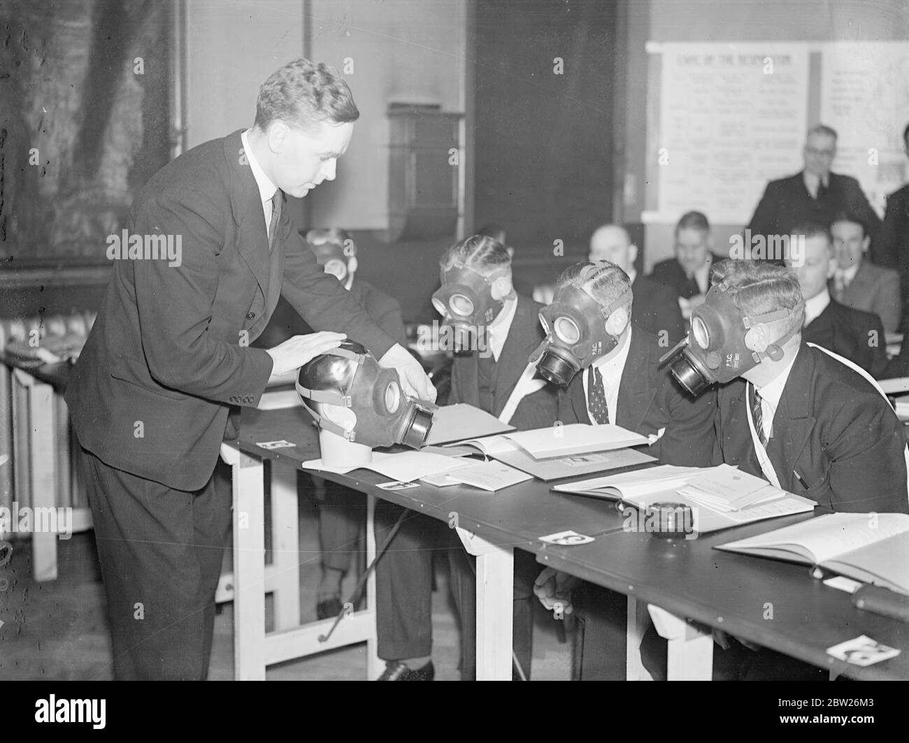 Anti-gas construction the city business representatives, first school in city. At the first anti-gas school in the City of London, situated somewhat aptly at the city mortuary in Golden Lane, instruction is being given in the use of respirators and methods of combating known war gases. Representatives from big business houses and the Bank of England, attend the school. The object is to ensure that eventually all big business houses will have a responsible person educated in anti-gas and air raid precautions. Photo shows, Mr WR McGrath, instructor to the civilian Anti-Gas School, lecturing the Stock Photo