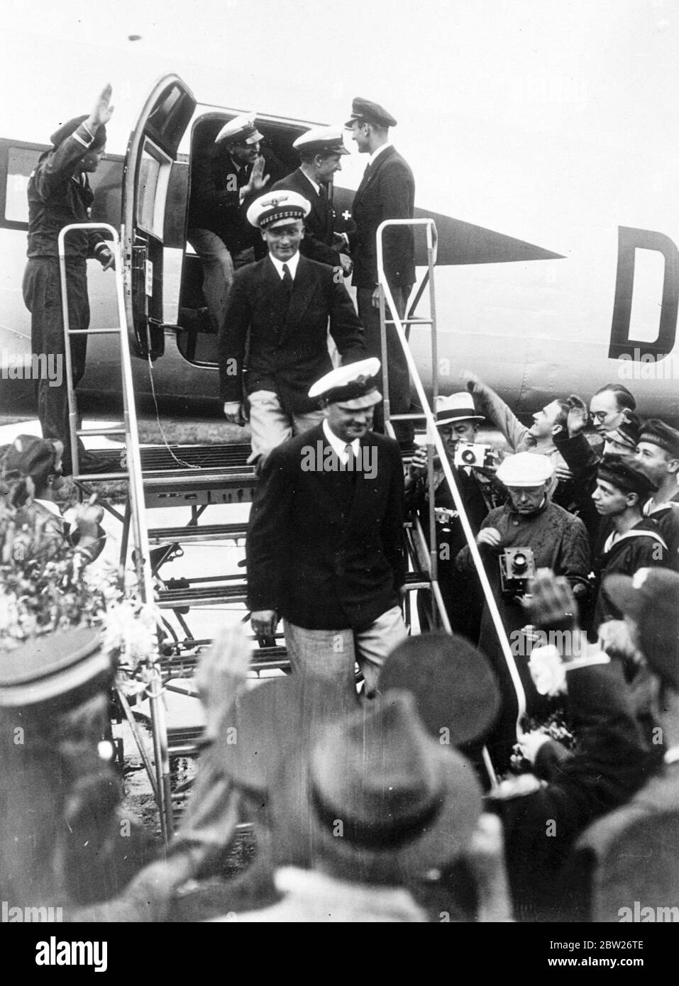 German aircrew welcomed home after record-breaking Atlantic flight. The German airliner 'Brandenburg' which had flown from Berlin to New York in 24 hours 56 minutes, landed at Tempelhof Aerodrome, Berlin, after they return flight of 19 hours 54 minutes. This was the fastest flight from New York to Berlin and easily beat the record set up by the round the world flyer Wiley Post in 1933, of 24 hours 45 minutes. The crew of the machine, Captain Henke, Captain von Moreau, Radio Operator Kober and Mechanic Dierberg, were given a tremendous welcome home, and were received at the Air Ministry by Gene Stock Photo