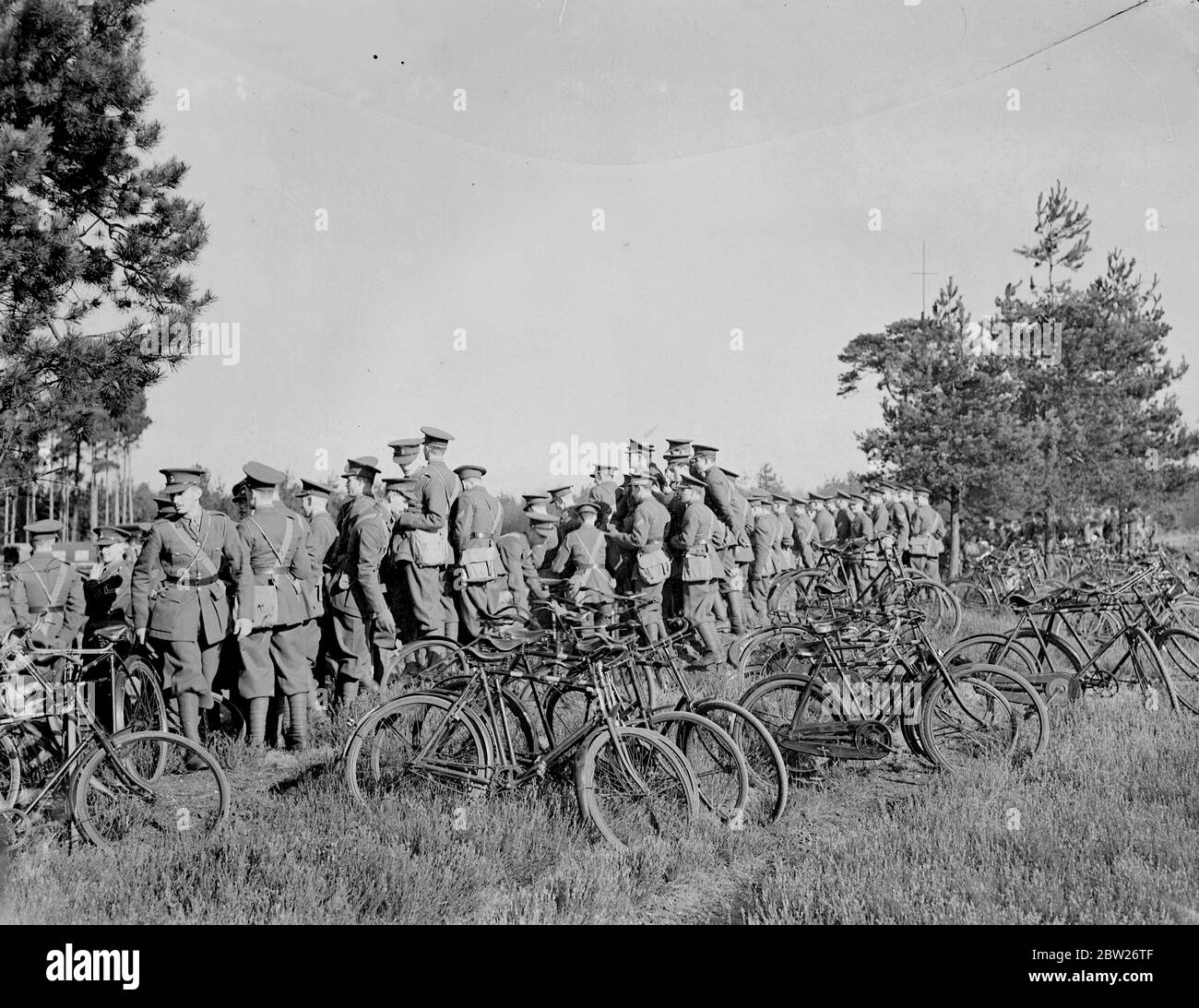 Military cadets see artillery in action. Field battery at war strength gave a demonstration near Camberley (Surrey) from the instruction of cadets from the Royal Military College (Sandhurst). Photo shows, cadets watching the artillery in action from hillock. 2 March 1938 Stock Photo
