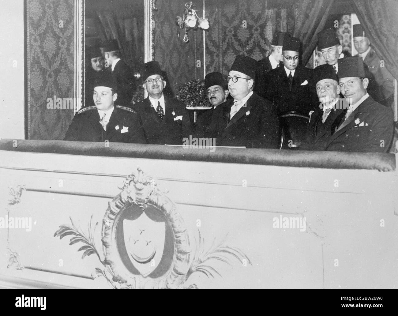 King Farouk opens Cotton Congress. First official duties since is wedding. King Farouk of Egypt, made his first official appearance since his marriage when he opened the International Cotton Congress at the Opera house in Cairo. Photo shows, King Farouk (left) with Prince Abel Monein and Mohamed Mahamed Pasha, the Prime Minister, at the opening of the Congress. 1 February 1938 Stock Photo