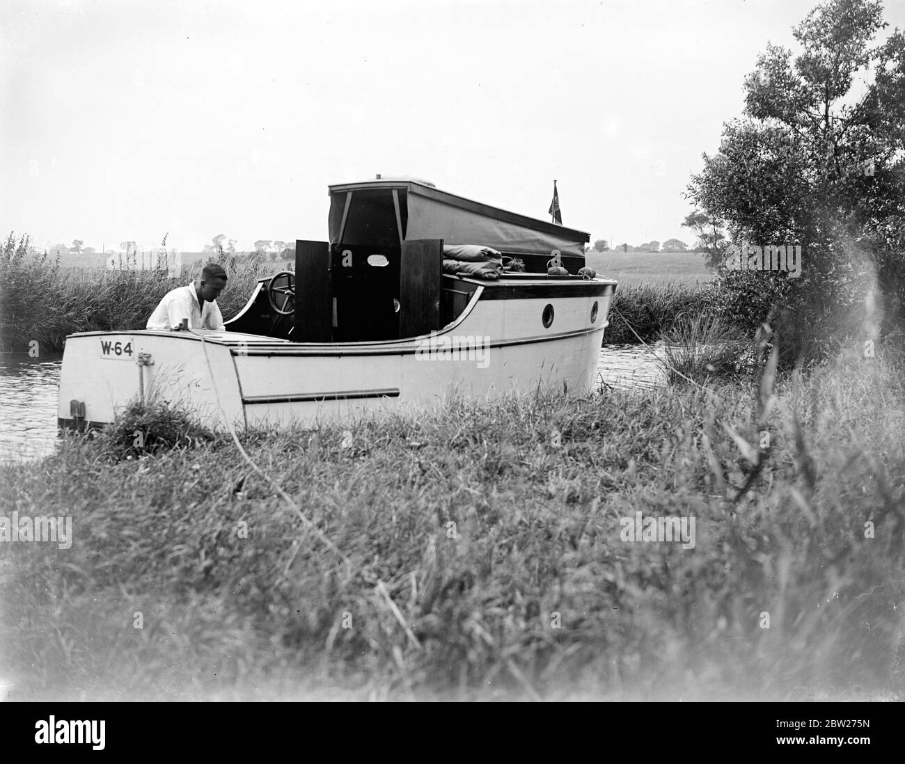 A cruiser in daylight on The Broads. 1933 Stock Photo