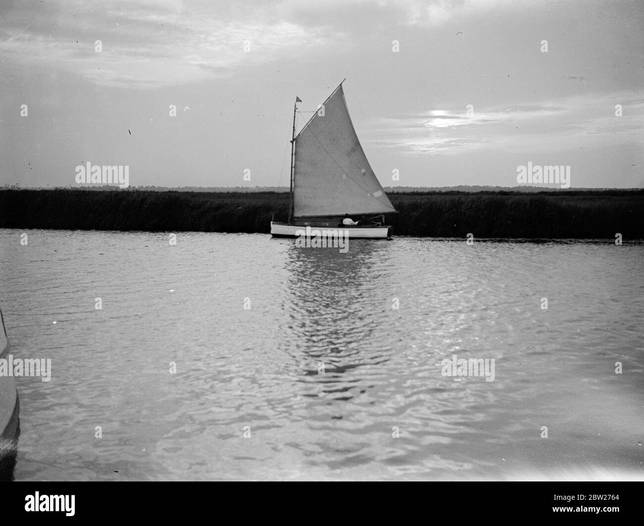 Sailing through The Broads. A yacht. 1933 Stock Photo