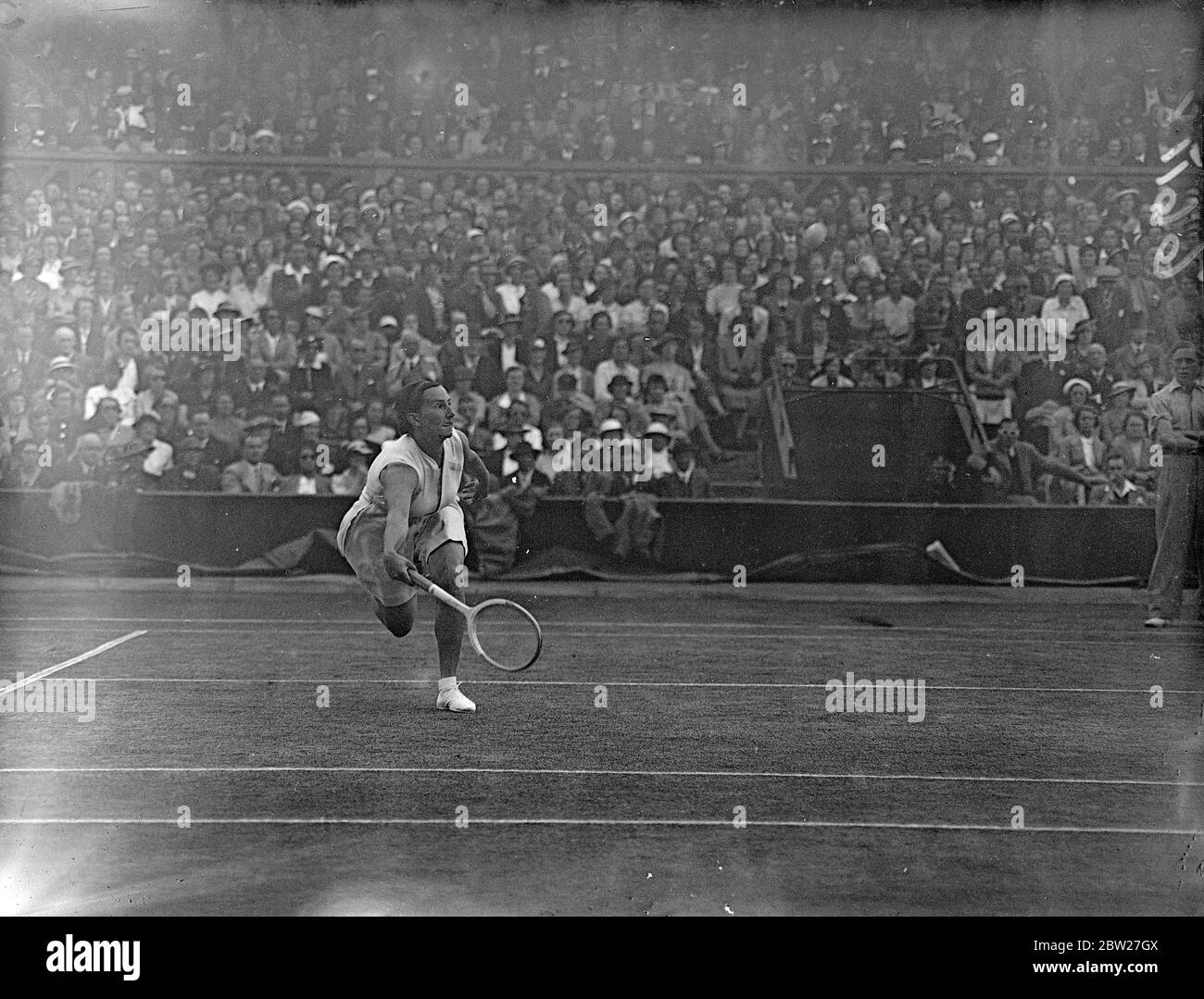 Miss Dorothy Round of Great Britain in play against Mme R. Mathieu, whom she beat 6 - 3, 6 - 0 in the semi-final of the women's singles on the Centre Court at Wimbledon. She will now meet Mme J. Jedrzejowska of Polland in the final. 1 July 1937 Stock Photo