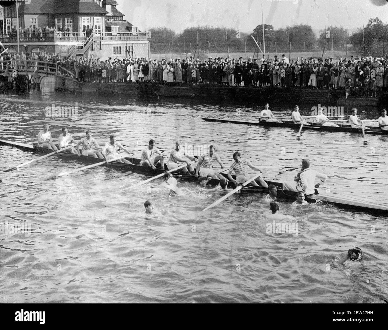 Supporters of the New College crew swam out to the oarsemen with beer after the crew had emerged Head of the River from the Oxford Summer Eights. New College wrested the headship from Oriel, who had held it for the record time of four years. 27 May 1937 Stock Photo