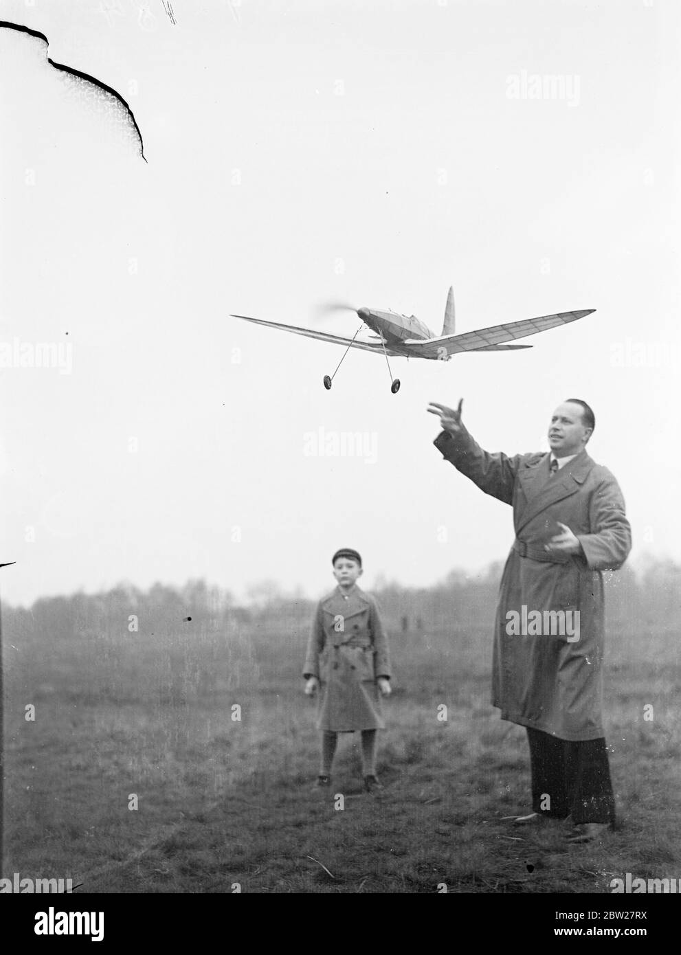 Nephew of Czech president flies model planes in London. M Benes, the nephew, and three-year-old Bohus Benes, grandnephew of the Czechoslovakian President, took part in the flying of model aeroplanes on Wimbledon Common, London. M Benes, who is a model aeroplanes enthusiast, is an official of the Czech Legation in London. Photo shows, M Benes launching a model plane on Wimbledon Common. 22 Janary 1938 Stock Photo