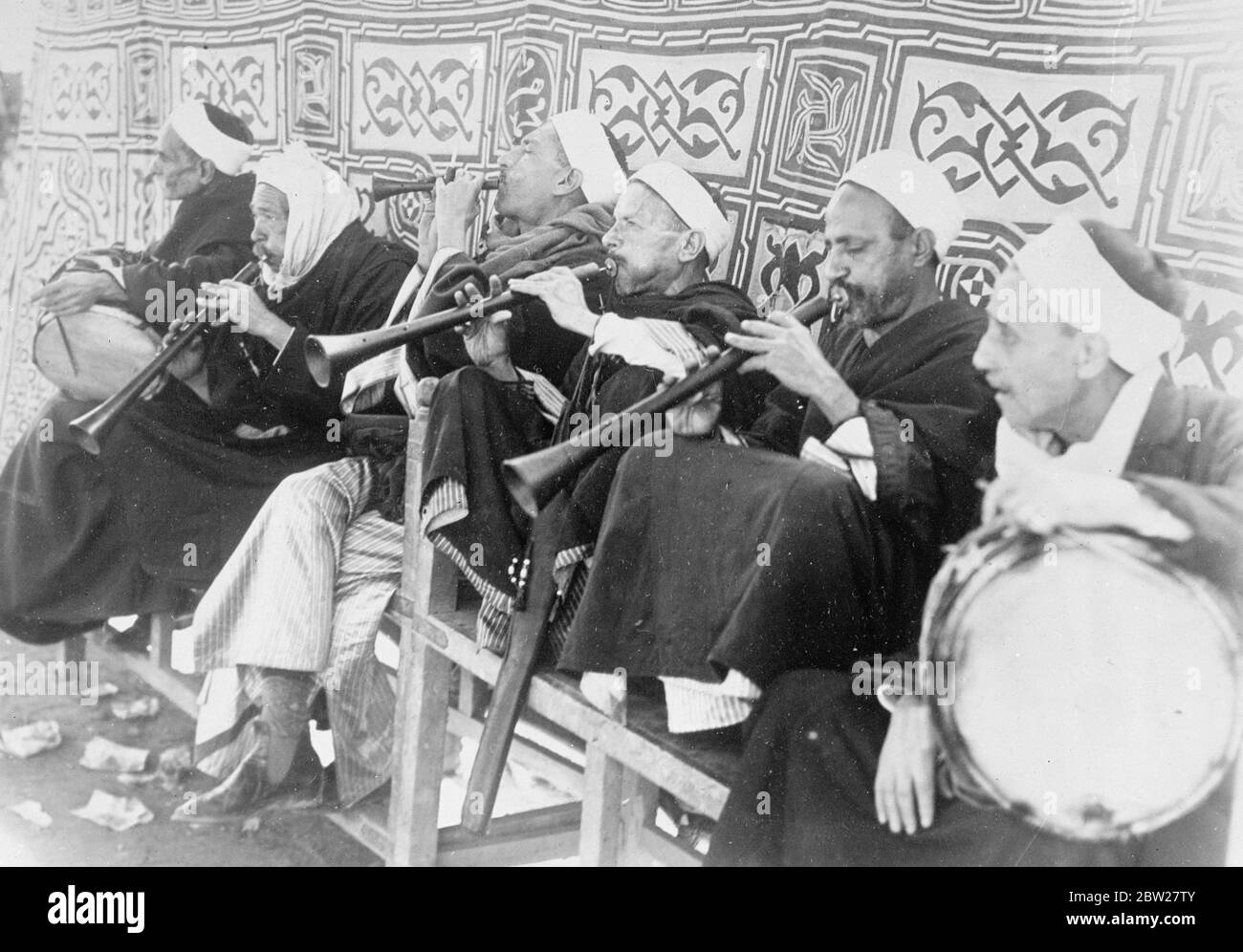 Pipers at the wedding. King Farouk in Cairo. With traditional Muslim ceremony, 17-year-old King Farouk of Egypt, was married at the Koubbeh Palace in Cairo, to Miss Farida Zulficar Pasha, the judge of the Egyptian court of appeal. Photo shows, Egyptian pipers and drummers playing in the garden of the Koubbah Palace during the wedding. 23 January 1938. Stock Photo