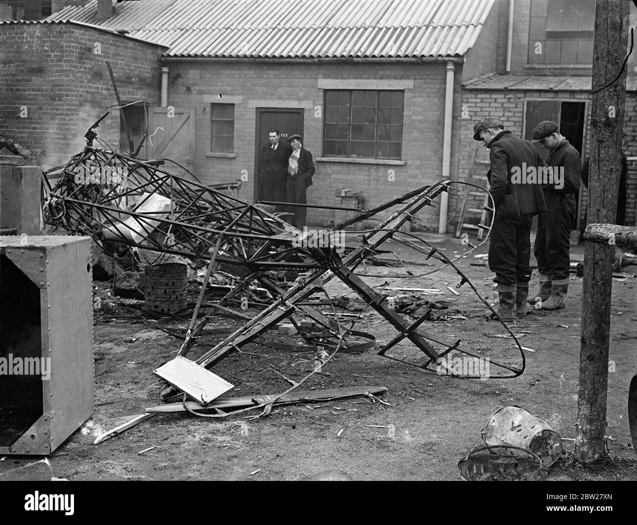 Three die when RAF and civil plane collided over Hertfordshire. Planes crash in brickworks. Three men, an RAF officer and a pilot instructor and pupil were killed when a Gloucester Gauntlet Plane from Duxford and a de Havilland Tiger Moth plane collided in midair and crashed in flames at Smallford, near St Albans, Hertfordshire. The service plane fell in a field adjoining a brickyard and the civil machine, crashed into a gravel pit, causing 20 men to run for their lives. Photo shows, the tangled wreckage of the civil Tiger Moth amongst the buildings of the gravel pit. 21 January 1938 Stock Photo