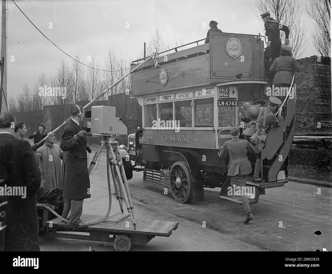 Famous wartime bus televised in pageant of transport at Chiswick. London's buses, from the old horse-drawn vehicles to 'Old Bill' and the modern Leviathans seating over 60 people, were televised in a 'Pageant of Transport' at London transport's Chiswick depot. The buses, which were manned by men in appropriate costume, were brought from London transport's own museum. Photo shows, 'Old Bill', the bus which carried thousands of British troops during the great War, being televised at Chiswick. 14 January 1938 Stock Photo