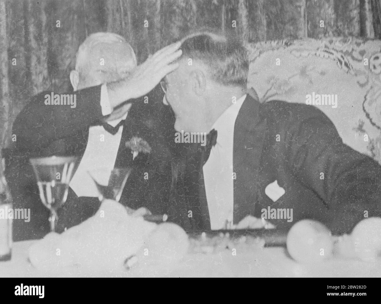 Back slapping goes to the head. President praised by his deputy. Vice President John Nance Carner (left) in joyous mood, proudly pats President Franklin D Roosevelt on the head at the Democrat Jackson Day dinner in the Mayflower Hotel, Washington, District of Columbia. 19 January 1938 Stock Photo