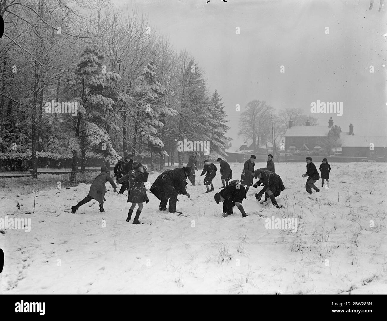 First snow of the New Year in Home Counties. The return of colder weather has brought the first heavy snowfall of the New Year in the Home Counties. There is a deep covering in the Henley-on-Thames district of Oxfordshire. Photo shows, snow fight in progress at Nettlebed near Henley. 10 January 1938 Stock Photo