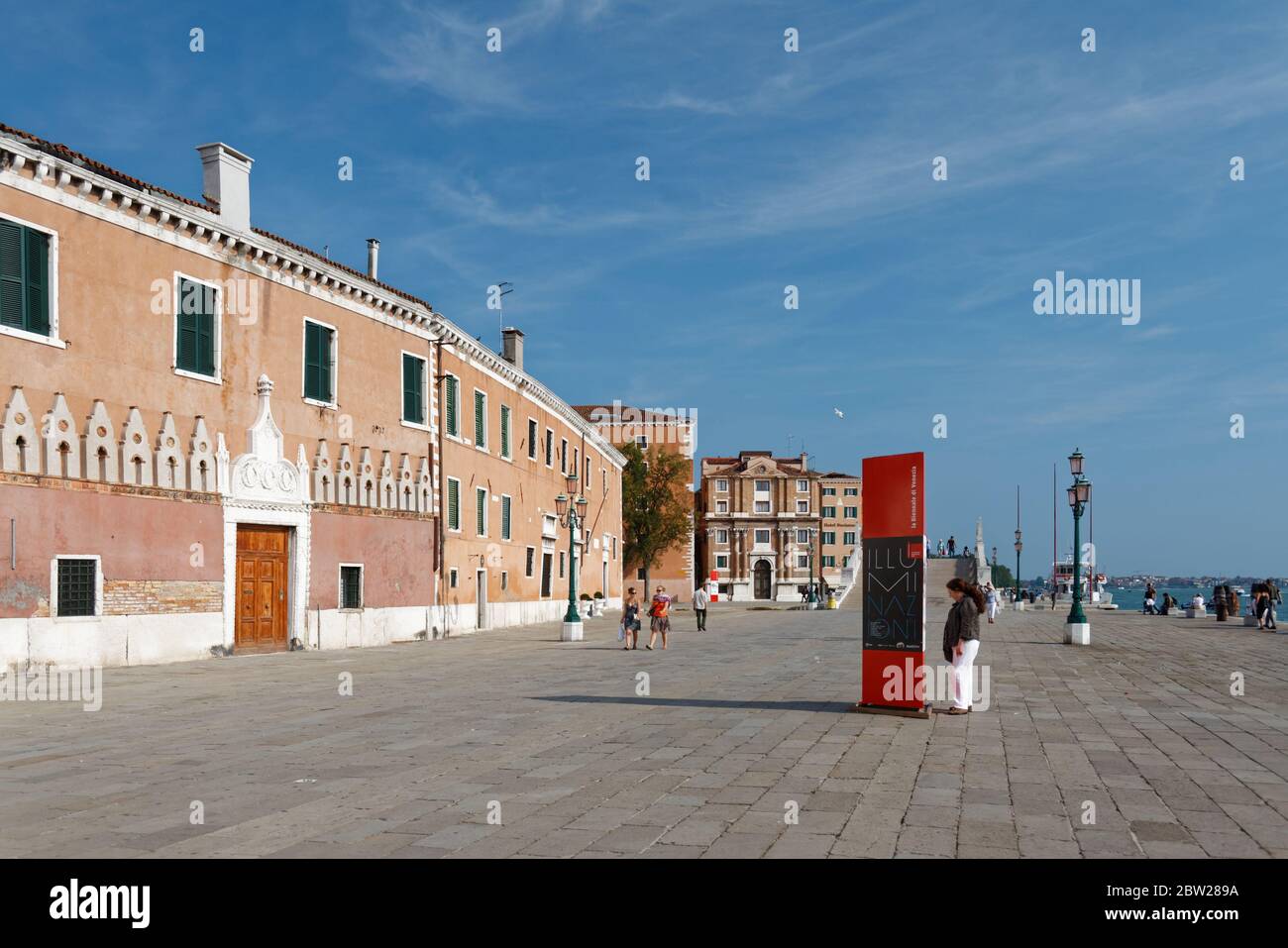 Sep 23/2011: Waterfront near the Arsenale stop of the vaporetto. One person is reading the Biennale plan. Stock Photo