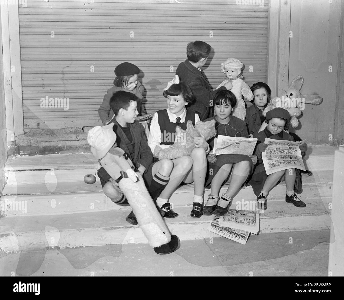 Mother masquerades as girl of 12, goes to school and plays with dolls. With a large white bow in our dark, bobbed hair and wearing a neat drill slip, conventional schoolgirls attire, 'Chibby' Cohen of Hammersmith (London) went to school for several months with friends. But at the end of the term. The school authorities wanted to transfer her. This would have taken her away from her friends, and as 'Chibby' didn't want this to happen. An amazing masquerade was revealed. Although apparently only 12 years old, 'Chibby' was Mrs Edward Cohen, a married woman 24. She had had a baby which, however, h Stock Photo