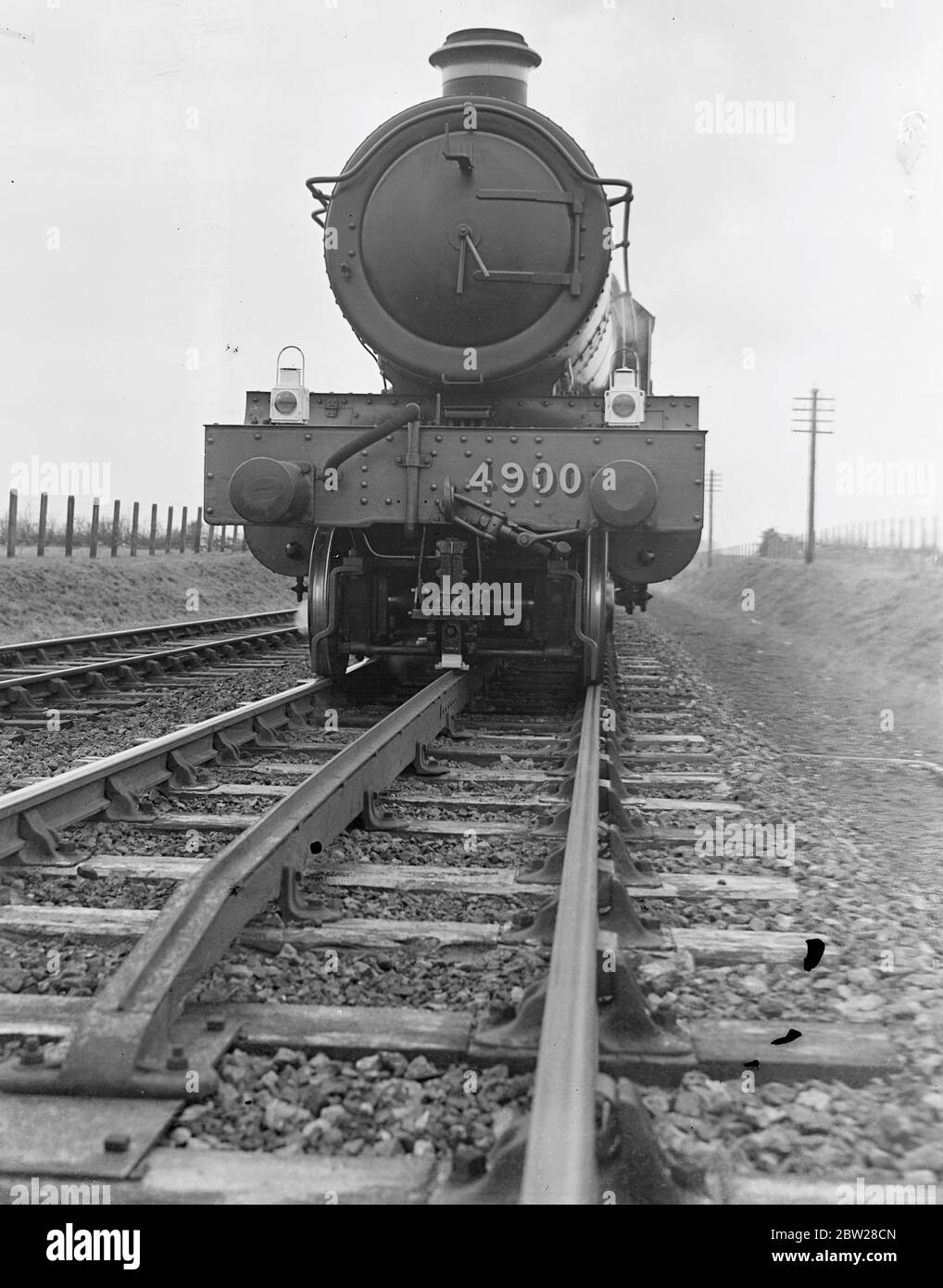 Britain's railways overcome the fog menace - audible signals warned driver and apply brakes. A device, invented by members of the railway staff, which gives audible warning to the drivers, has been installed as a safety aid on the Great Western Railway System in England. If the line is clear a bell rings by the drivers side giving him the right of way. Should the signal be at 'caution' a siren sounds and the brakes are automatically applied throughout the train. And I am sure you fitted beneath the locomotive connects with the ramp and so gives the signal to the driver. By means of this new sa Stock Photo