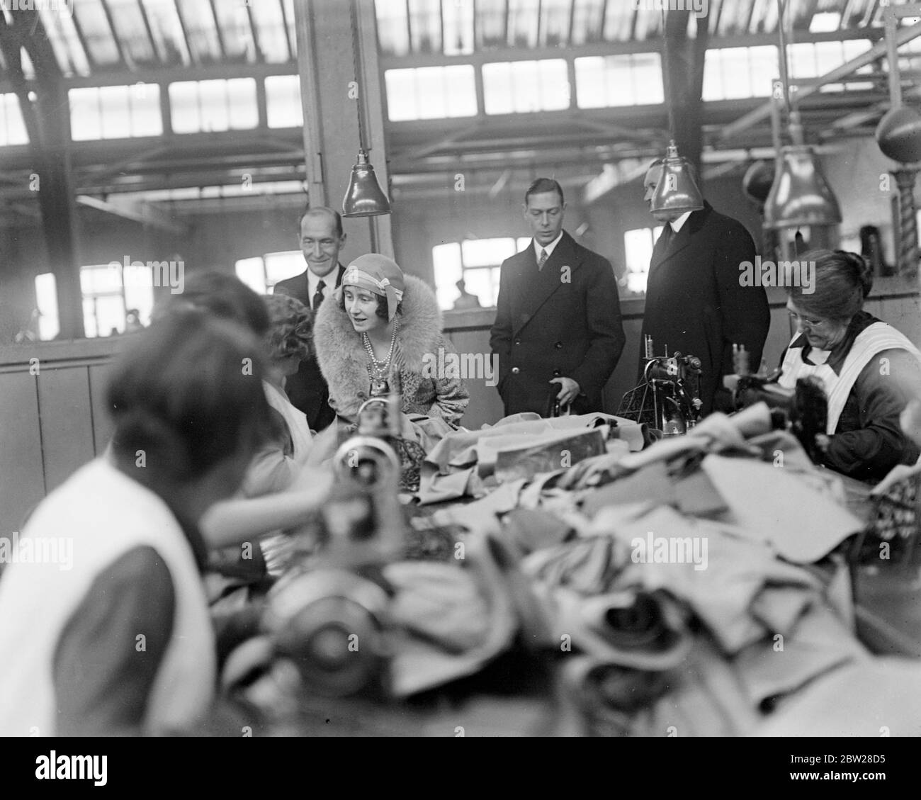 Duke and Duchess of York at army clothing depot. The Duke and Duchess in the sewing department. 8 December 1930 Stock Photo