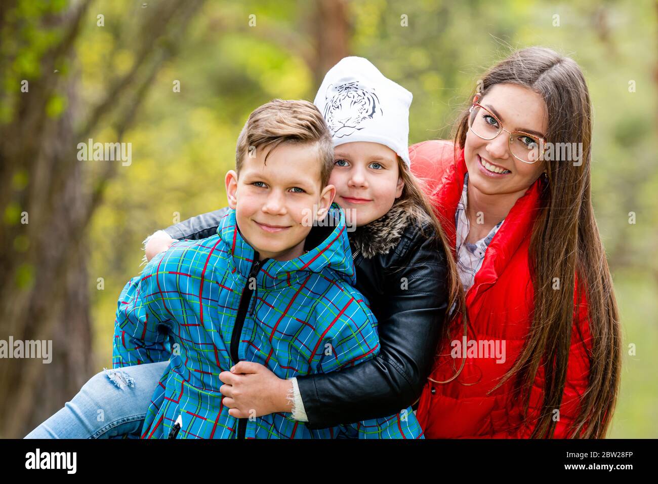 happy family walks through the woods and enjoys a warm spring day Stock Photo