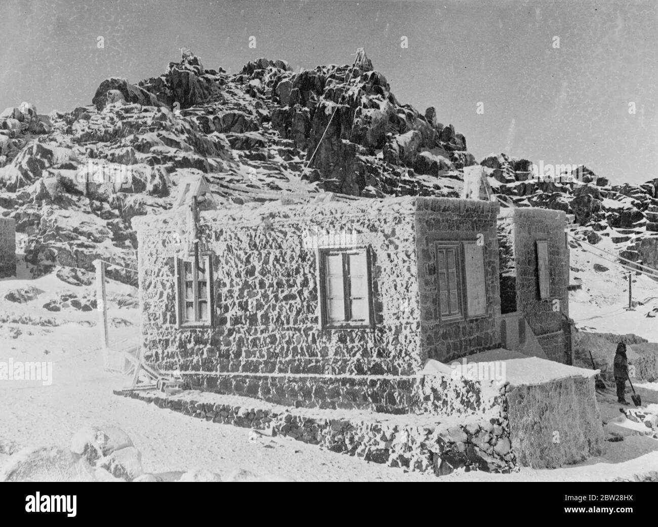 American observatory on the 'The Mount of Moses in Egypt'. Set on the highest peak in Egypt, the rugged, snowcapped Mount Sinai , which rises 11,000 feet above the arid deserts of the Sinai Peninsular, is the Solar Observatory of the Smithsonian Institution of America. Here, a staff of scientists carry out their observations of the heavens. Mount Sinai, which is on the peninsula of the head of the Red Sea, between the Gulfs of Akabah and Suez, is known to the Arabs as 'Tebel Muse', Mount of Moses. Photo shows, the cottage of the observers on the snowy rugged slopes of Mount Sinai. A member of Stock Photo