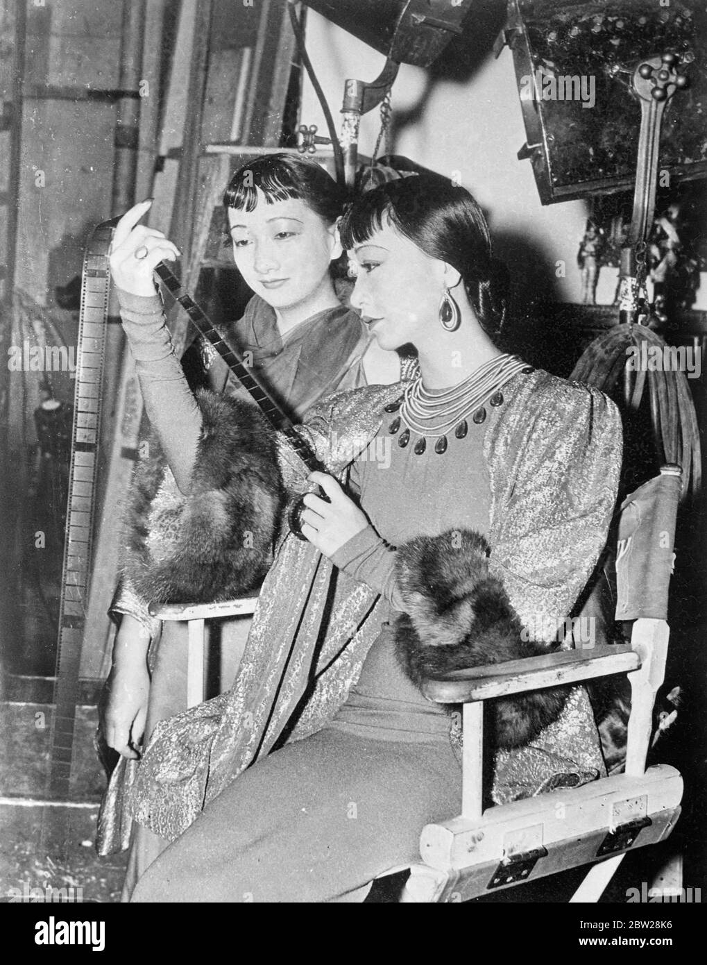 Anna May Wong has a new 'stand in'. Sister who fled from the China war. Anna May Wong, the Chinese film actress, has a new 'standi n'. Her sister, Wong Lin Heung, who recently fled from war-torn Shanghai, where she was secretary in the Customs office, is now working as Anna's 'double' in the Hollywood studios. Anna May Wong's former 'stand in' was her schoolgirl cousin, Frances Wong, who has returned to her studio is at the University of Southern California. The 'stand in' says the actual actor or actress a great deal of trouble in Hollywood. She must resemble the actress as closely as possibl Stock Photo