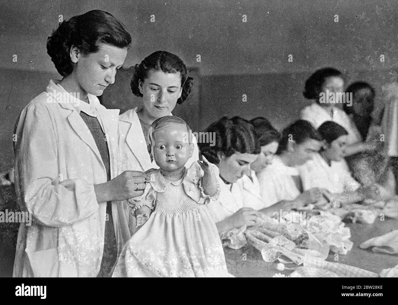 The new turkey trains mothers of the future. Freed from the veil and the restriction of the pre Kemal regime, women in the new Turkey are taking a part in public life undreamed of by the women of only a quarter century ago. Education and physical fitness are primary objects of the younger generation, which is making Turkey one of the most progressive of European nations. But girls are trained not only for buisness careers, as mothers of the future they are taught infant welfare and housewifery at special colleges. Photo shows, well dressed and well groomed girl students, with dolls as models, Stock Photo