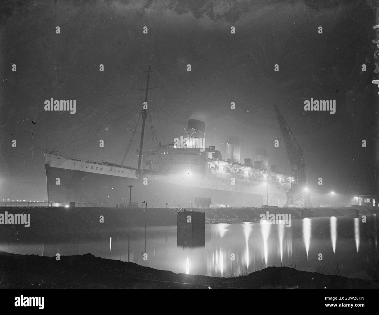 'RMS Queen Mary' in the glare of the floodlights. The giant liner