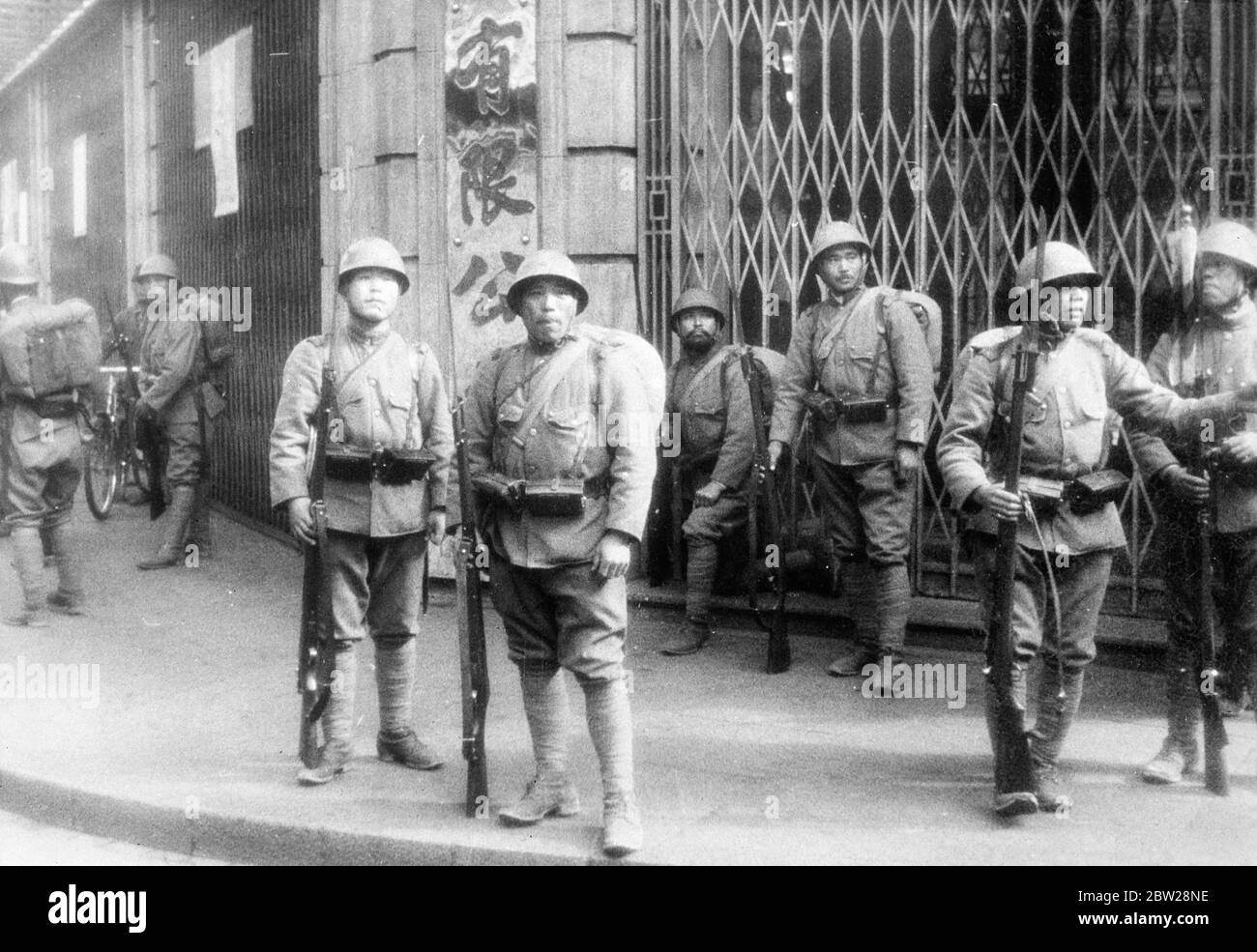 Chinese who threw hand grenade at Japanese 'Victory March' shot by Chinese policeman in International Settlement. Exclusive pictures of the incident. These exclusive pictures, just received in London, were taken when a Chinese threw a hand grenade in the mist of 5000 Japanese soldiers who were taking part in a victory march through the International Settlement at Shanghai. Several of the Japanese were injured and the Chinese who was responsible for the explosion was shot dead by a Chinese policeman of the settlement. The incident was followed by great confusion, the Japanese troops scattering Stock Photo