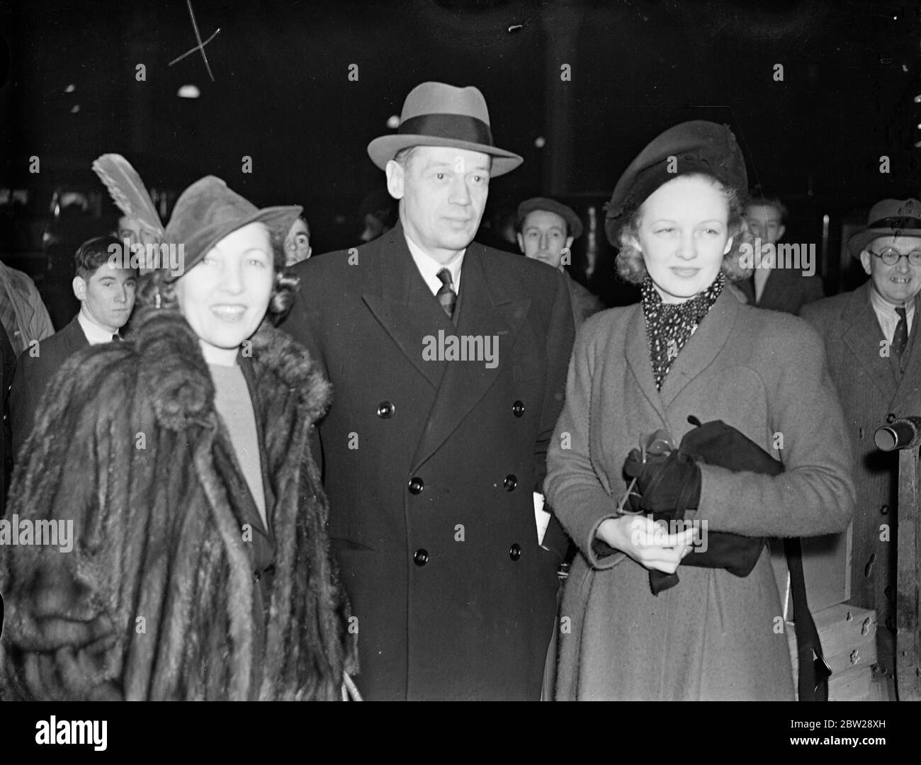 Ely Culbertson arrives in London as wife seeks Reno divorce. Mr Ely Culbertson, the American bridge player, arrived at Paddington station on the 'Queen Mary'boat train to spend Christmas in England. His wife is on her way to Reno to obtain a divorce from him after 14 years of married life. 'I hope that after the divorce, we shall remain bridge partners', says Mr Culbertson. 'I still love her, I shall never marry again'. Photo shows, Mr Ely Culbertson with Mrs Charles Butterworth (left) and Lady Jersey (right) on arrival at Paddington. Lady Jersey was formally Virginia Cherrill, the film actres Stock Photo