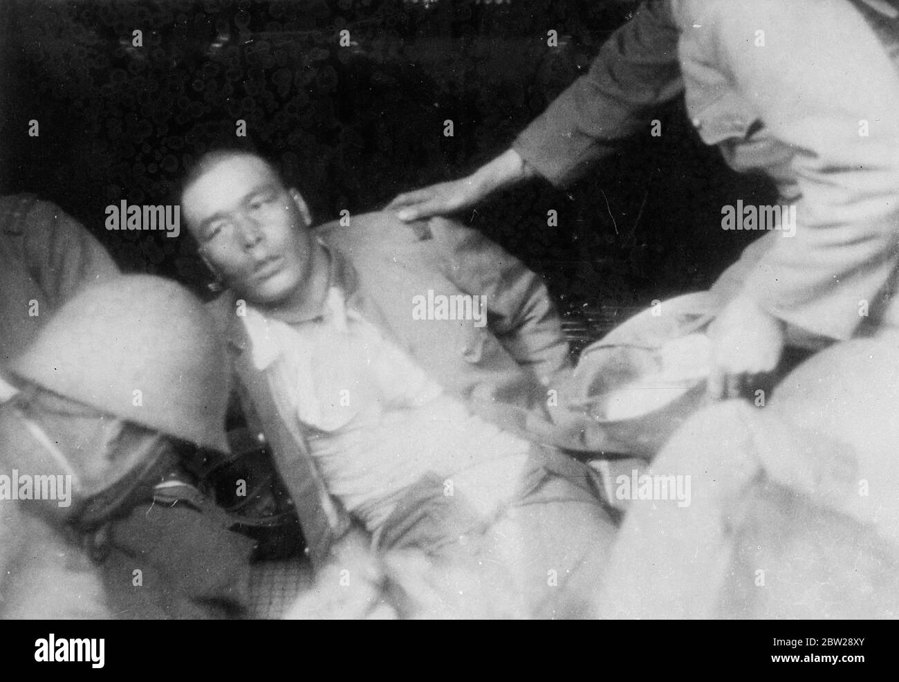 Chinese who threw hand grenade at Japanese 'Victory March' shot by Chinese policeman in International Settlement. Exclusive pictures of the incident. These exclusive pictures, just received in London, were taken when a Chinese threw a hand grenade in the mist of 5000 Japanese soldiers who were taking part in a victory march through the International Settlement at Shanghai. Several of the Japanese were injured and the Chinese who was responsible for the explosion was shot dead by a Chinese policeman of the settlement. The incident was followed by great confusion, the Japanese troops scattering Stock Photo