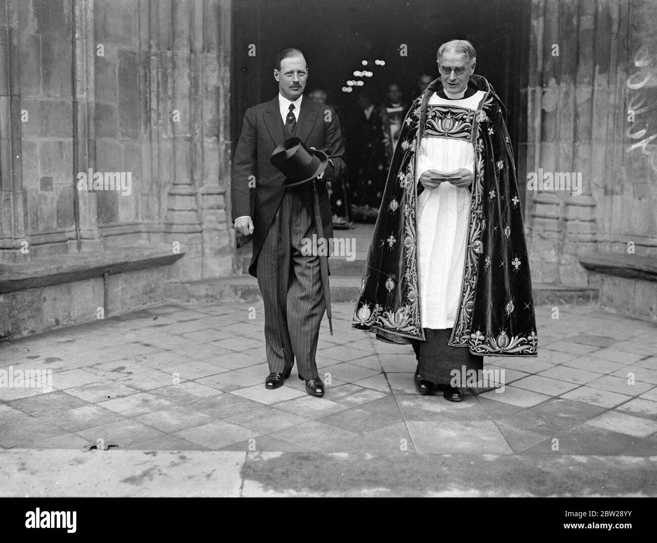 Kings Representative leaves with Canon Storr after Abbey funeral of Lord Rutherford. The ashes of Lord Rutherford, the eminent scientist, were buried in Westminster Abbey. The funeral was attended by statesman as well as leading scientists. Photo shows, Canon V F Storr, Sub Dean of Westminster, and Lord Fortescue, the King's representatives, leaving after the funeral. 25 October 1937 Stock Photo