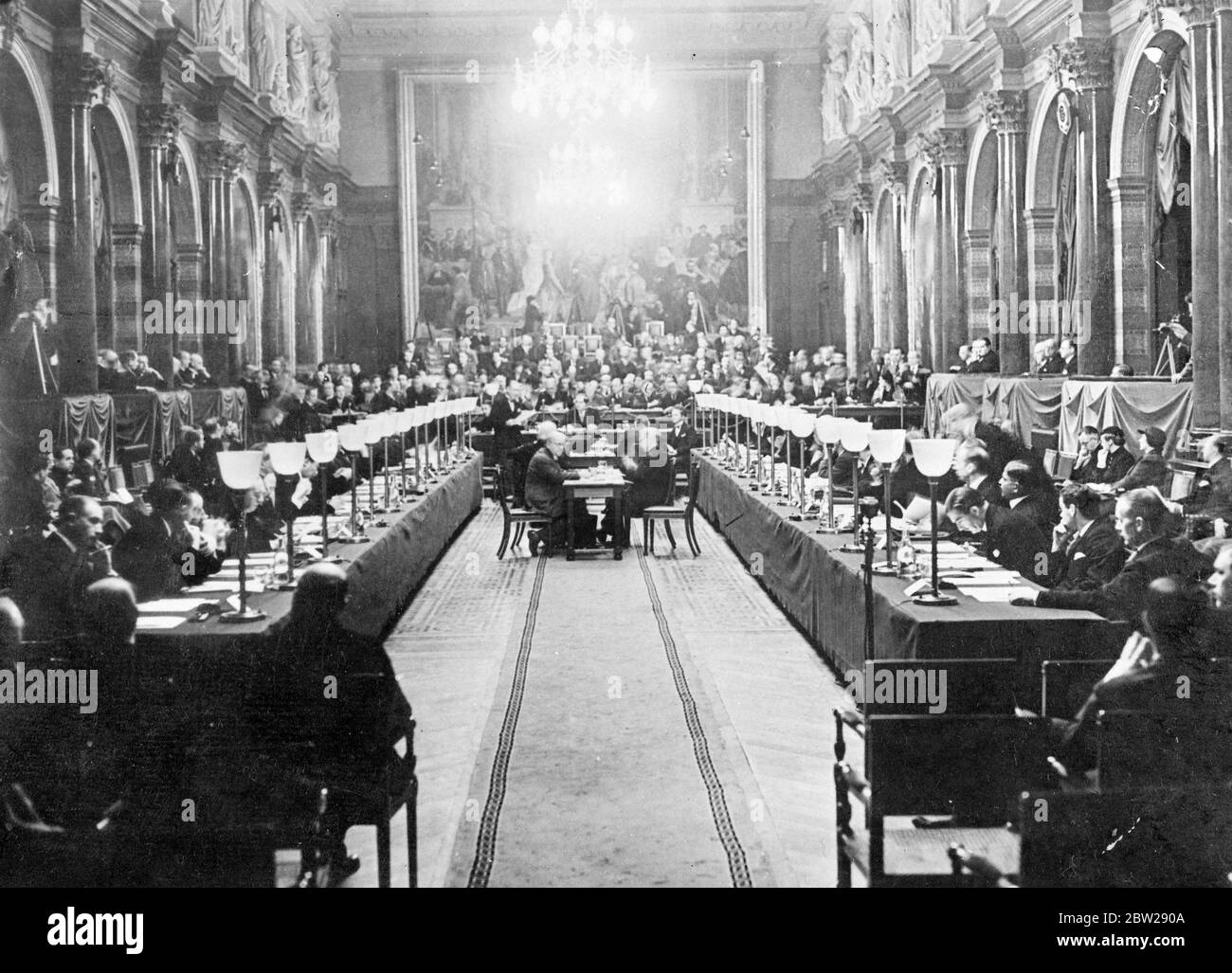 Nine Power Conference on China opens in Brussels. Action confined to mediation. That Britain will fully support the United States is seeking a peaceful settlement of the dispute was the main point in the speech by Mr Anthony Eden, British Foreign Minister, at the opening of the Nine Power Conference on the Sino Japanese hostilities, at the Palais des Academies in Brussels. Delegates from 19 nations attended, but Japan was not represented. She refused to attend photo shows, Mr Anthony Eden, studying his papers at the opening session of the Conference. Beside him (right) is Mr Malcolm MacDonald Stock Photo