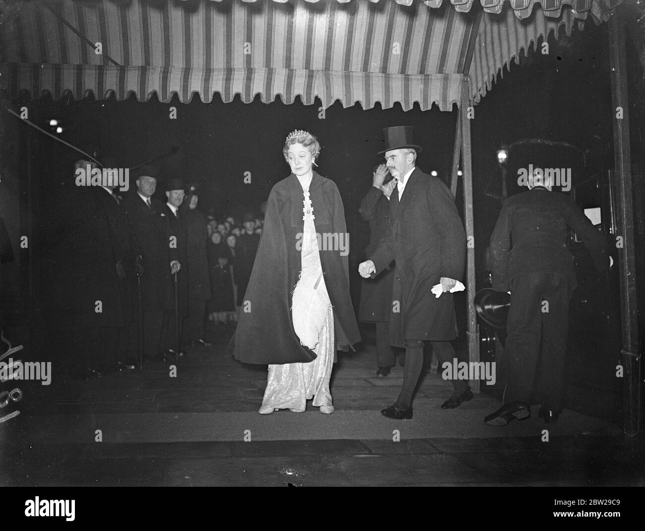 Mr and Mrs Chamberlain as guests of King Leopold at Belgian Embassy. The King and Queen, Queen Mary, and the Premier, Mr Neville Chamberlain, whether guest of King Leopold of the Belgians at the dinner given at the Belgian Embassy in Belgrave square. Photo shows, the Premier, Mr Neville Chamberlain and Mrs Chamberlain arriving at the Belgian Embassy. 17 November 1937 Stock Photo