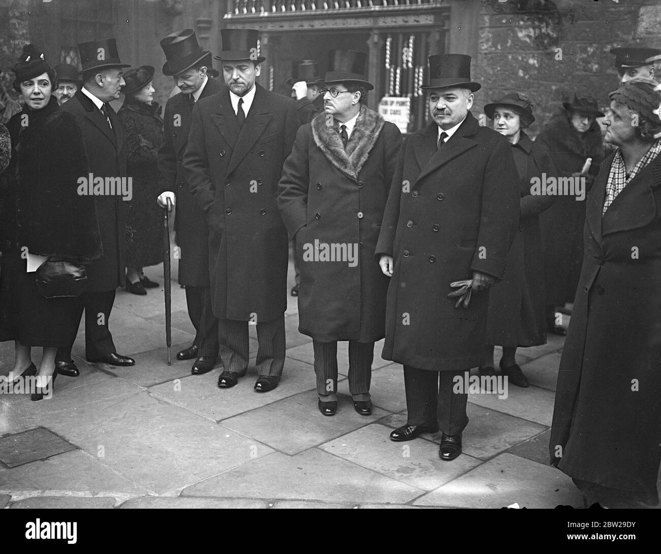 Ambassadors leave after funeral of Mr Ramsay MacDonald. The Premier, members of the Cabinet and Diplomatic Corps, attended the funeral Service in Westminster Abbey for Mr Ramsay MacDonald, England's first Labour Premier, who died at sea on holiday cruise to South America. Photo shows, Ambassadors, leaving after the service. From left to right Senhord Regis de Oliveira, (Brazil, Profile), Count Grandi (Italy), Baron Palmstierna (Swedish), and M Jean Maisky, (Soviet). 26 November 1937 Stock Photo