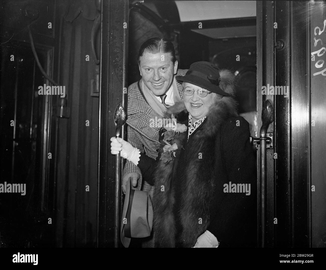 Jack Whiting, leaves for home with his wife. Jack Whiting, the American musical comedy actor, who has been appearing in London and filming with Jessie Matthews, left Waterloo Station with his wife on the 'Bremen' boat train from Waterloo to return to the United States. 6 November 1937 Stock Photo
