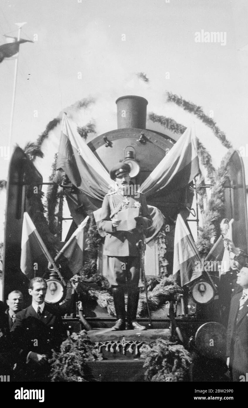 King Boris drives first train of a new Bulgarian railway line. King Boris of Bulgaria, the best-known amateur engine driver in the world, again took the footplate when he drove the first train over Bulgaria's important new railway line linking Sofia, with the Mediterranean. Photo shows, King Boris making his speech on May front of the first railway engine to use the new line. 19 October 1937 Stock Photo