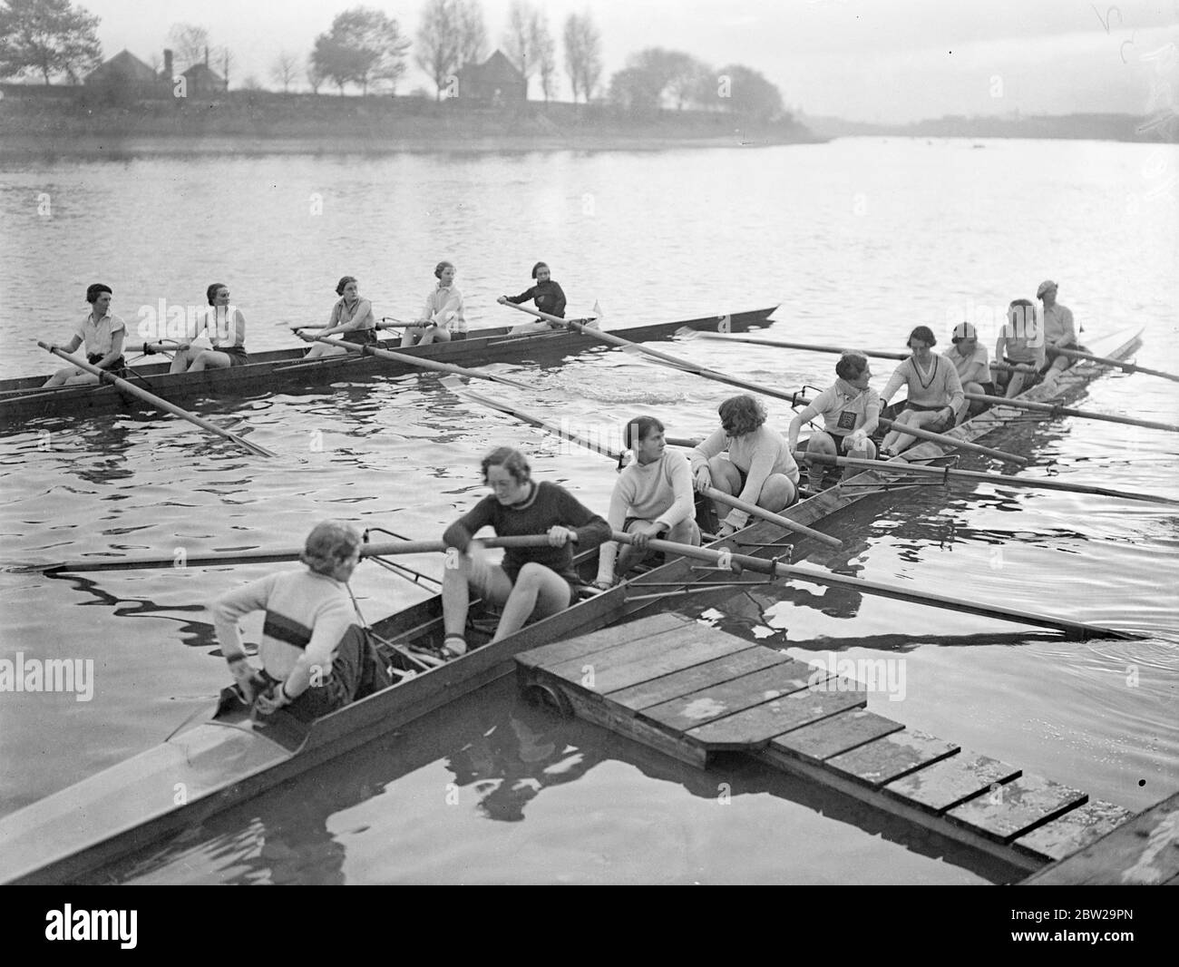 Roaring girl's regatta on the Thames. The annual Invitation Regatta of the Lyons Ladies Rowing Club took place on the Thames at Hammersmith, London. Photo shows, to the crews pushing off for the start of a race. 30 October 1937 Stock Photo