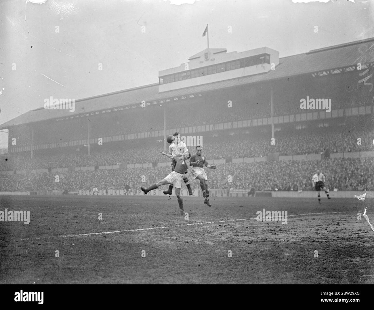 Czechoslovakia meet England at Tottenham's White Hart Lane. Meeting for the first time in this country, England played Czechoslovakia at the Tottenham Hotspur's ground at White Hart Lane, London. Photo shows, George Mills (Chelsea) and England centre forward (white shirt) heading between two of the Czech players in front of the Czech goal. 1 December 1937 Stock Photo