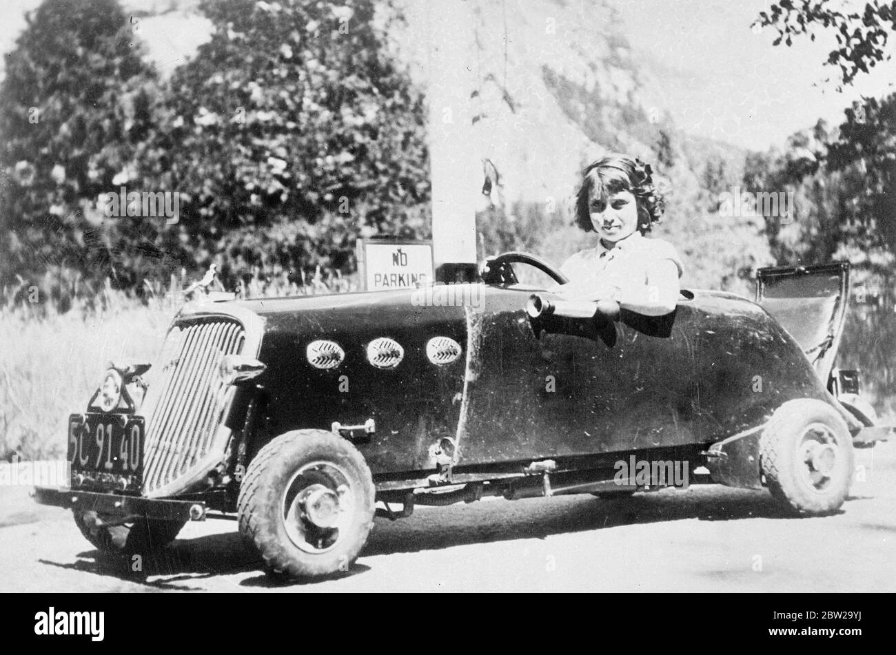 Nine-year-old Californian girl becomes youngest car driver. Makes 400 miles trip. Although only nine years old, Beverley Lancaster of Longbeach, California, has become the youngest licensed car driver in her home state. She has a miniature car, built for her by her father, powered by a glider motor, in which she can touch 40 miles an hour. Photo shows, Beverley Lancaster in her miniature 40 mile an hour car when she drove 400 miles to the Yosemite National Park. 26 October 1937 Stock Photo