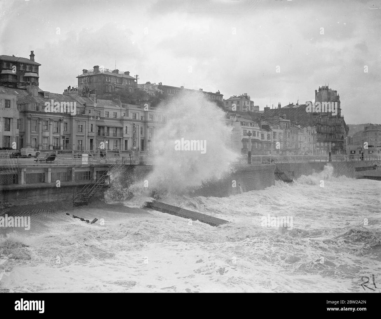 Huge waves broke over the front at Hastings during a Gale, which ravaged the south coast. Photo shows, giant waves which seemed to top the buildings breaking over the front at Hastings drama Gale. 23 October 1937 Stock Photo