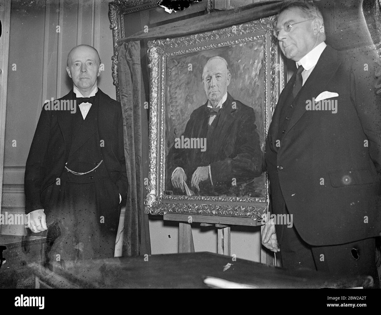 Portrait of Lord Runciman was unveiled by Sir Richard D Holt, President of the Chamber of Shipping, at the chamber of shipping, St Mary Axe City. Lord Runciman (left) with the portrait after the unveiling by Sir Richard D Holt (right) 28 October 1937 Stock Photo