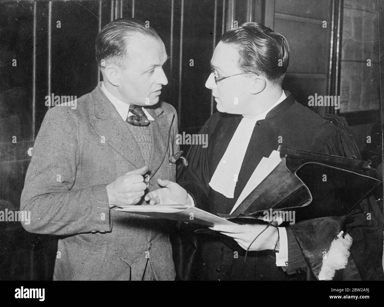Roger Hubert, in the Weidmann murder case, talking with his lawyer Mme Brun. Stock Photo